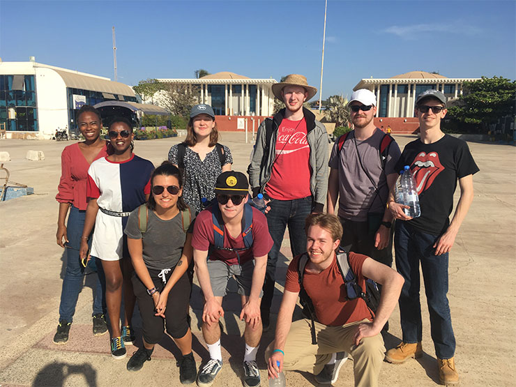 A group of young adults pose together on a trip to Senegal.