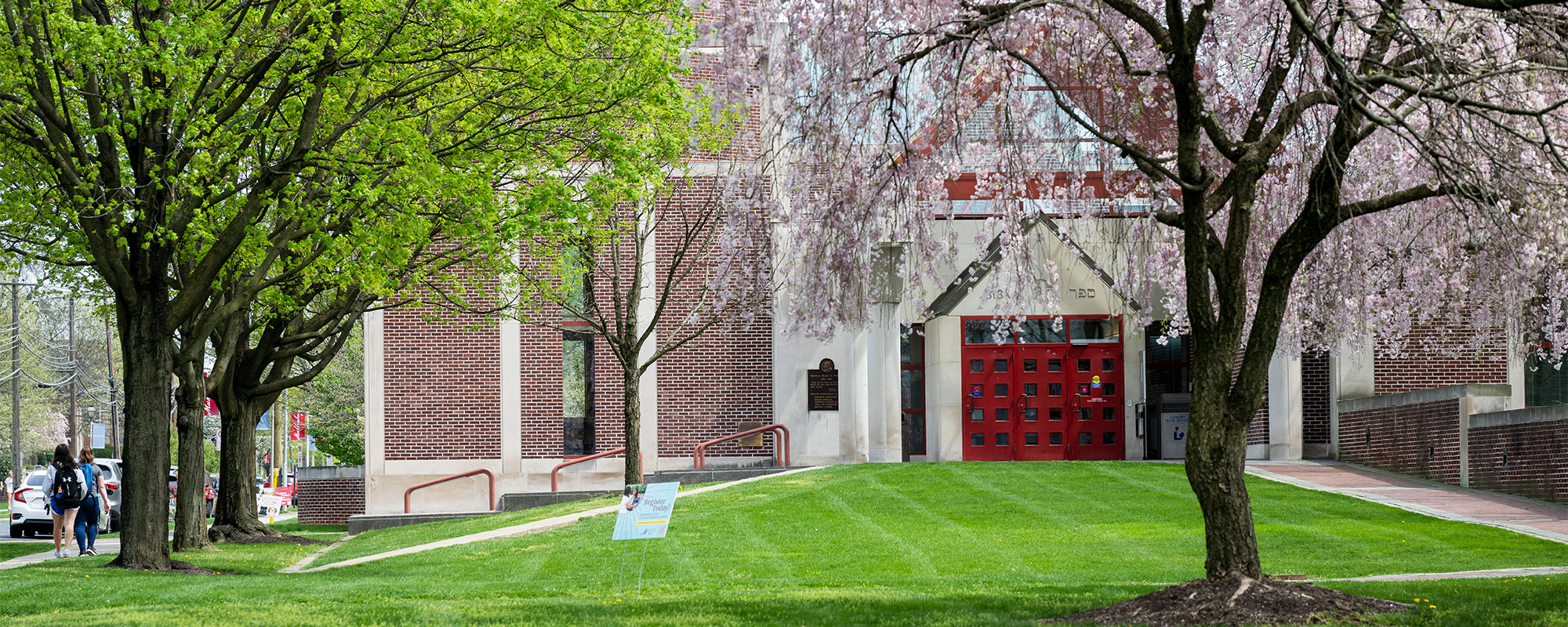 Spring blossoms and bright green leaves surround the Trexler Library on the campus of Muhlenberg College.