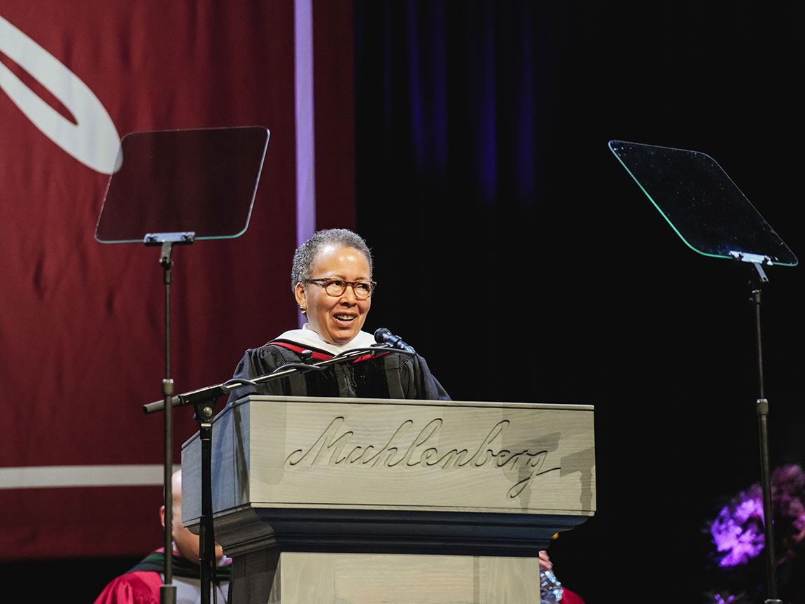 Commencement speaker Beverly Daniel Tatum, Ph.D. stands at a podium that says Muhlenberg