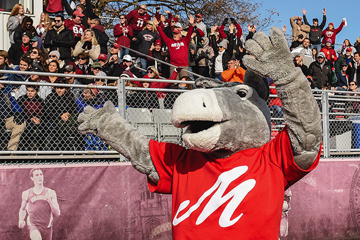 Mascot Marti the Mule cheering in front of stadium crowd