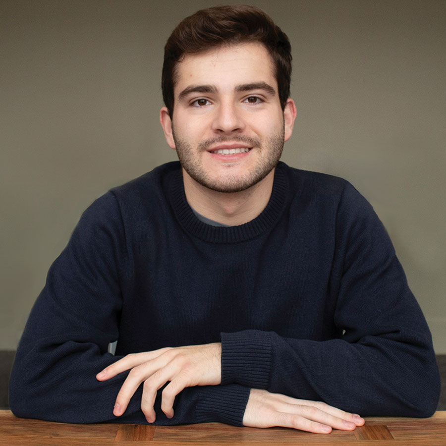 A portrait of a college student in a dark shirt.