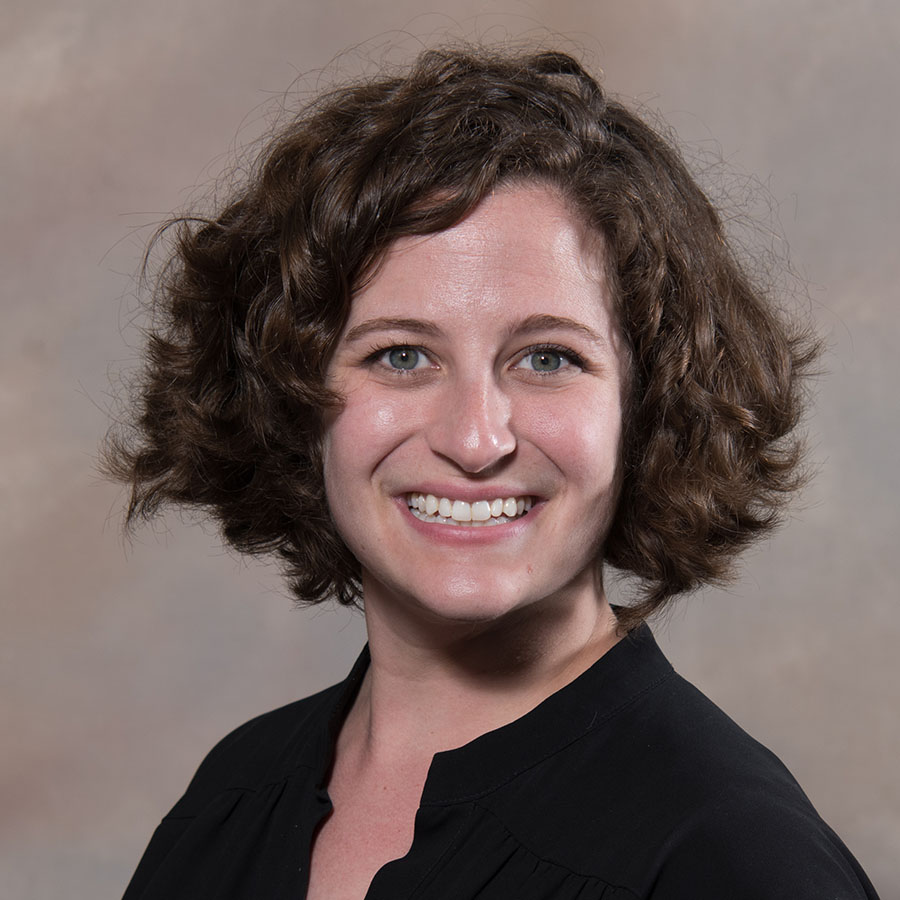 Profile image of faculty member Natalie Gotter posed, smiling in front of camera lens.