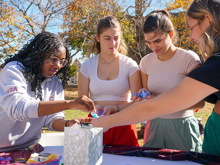 College students are taught how to make a tobacco tie as part of an event sharing Indigenous culture.