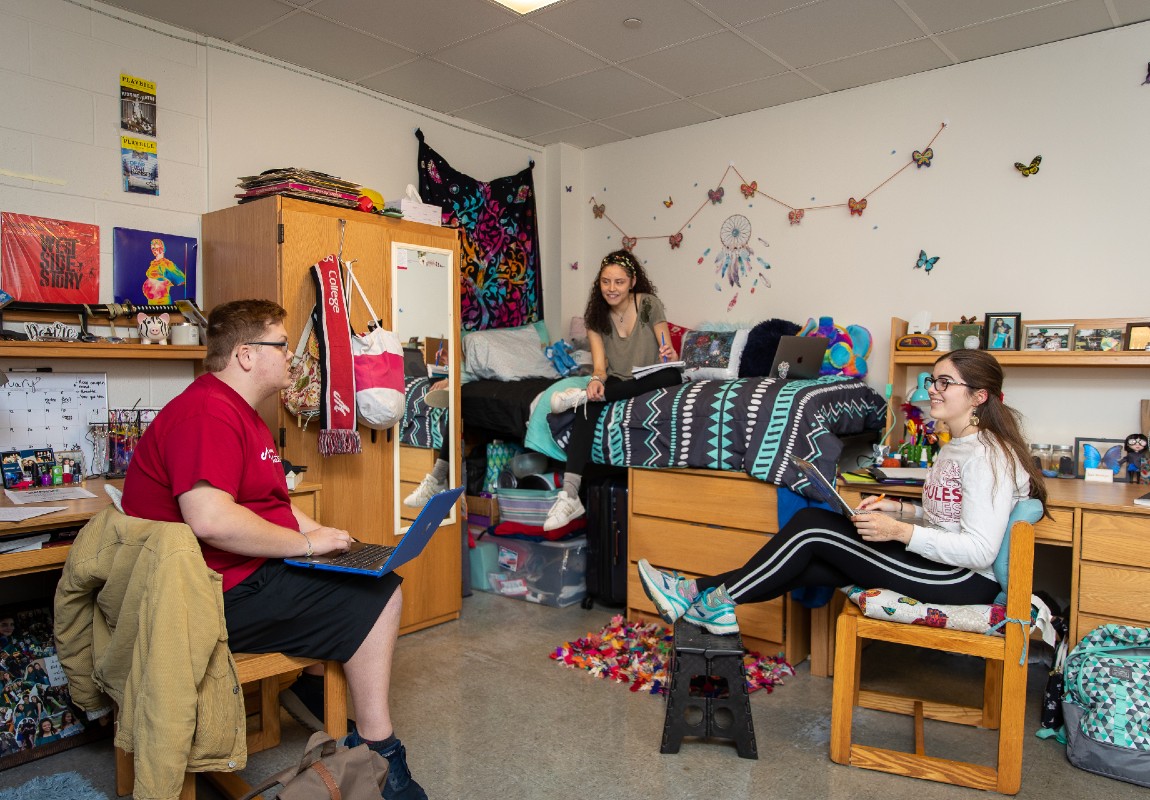 Students chat and study in a residence hall.