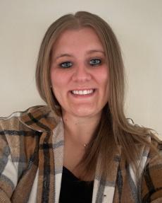 Assistant Director of Residential Operations, Paige Friesema, wearing a plaid collared shirt.