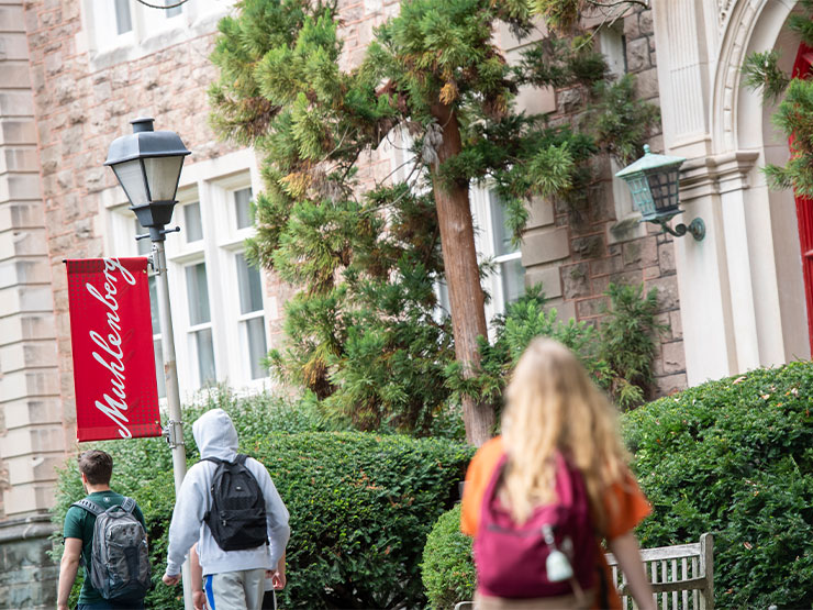 Students walk past Ettinger Hall on the Muhlenberg College campus.