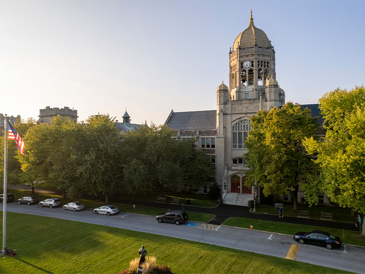 The Haas College Center clocktower and surrounding buildings on Muhlenberg College campus seen from above in the setting sun.