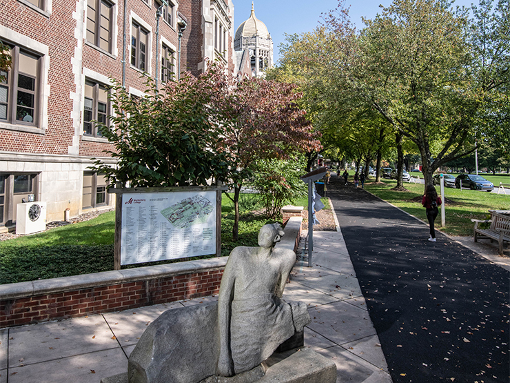 A sculpture of a woman reclining sits in Muhlenberg's Parents Plaza.
