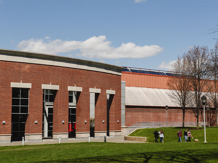 The red brick Muhlenberg Life Sports Center stands against a blue sky.
