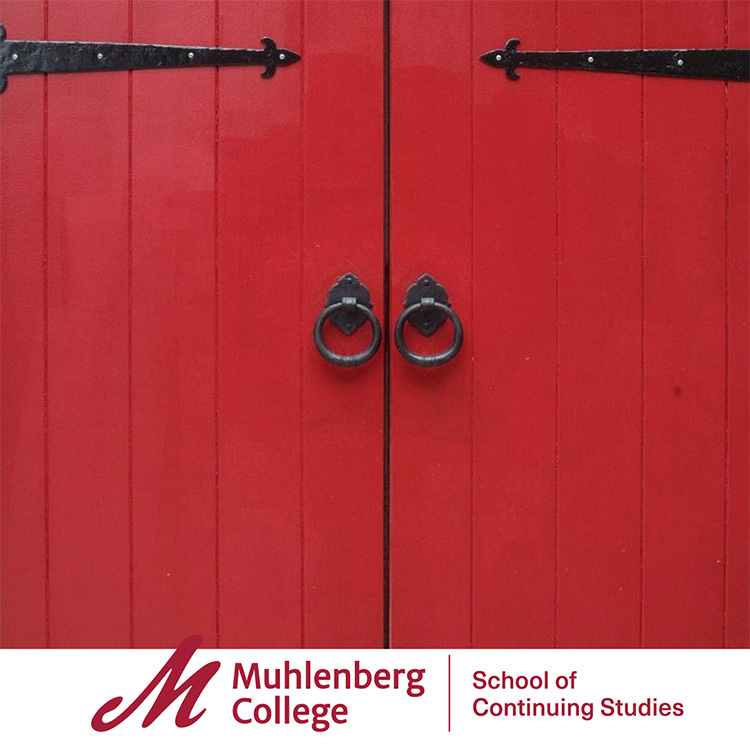 Large red doors with circular metal handles.