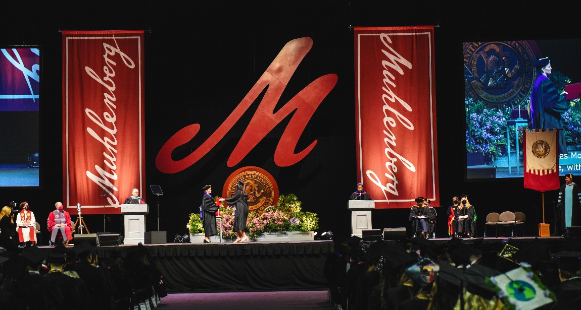 Student crossing the stage during Muhlenberg's 2022 Commencment ceremony.