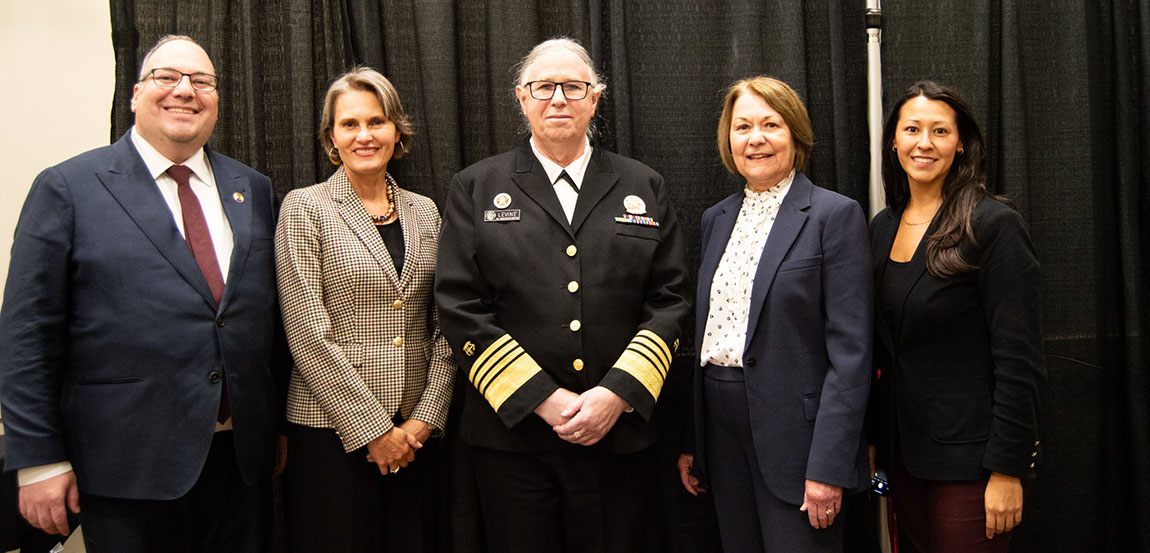 The U.S. Assistant Secretary for Health stands with three college administrators and the Acting Deputy Assistant Secretary for Health Policy