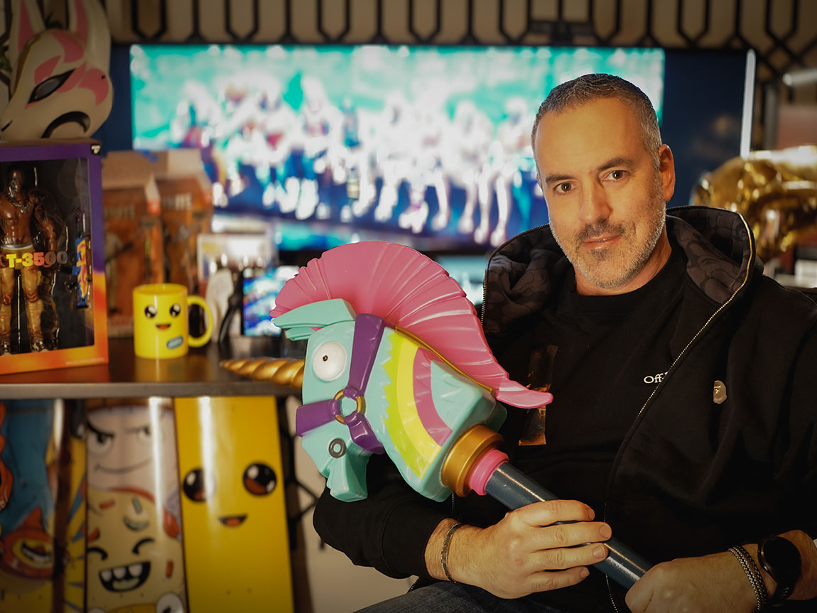 A man holds a unicorn head on a stick and other Fortnite memorabilia